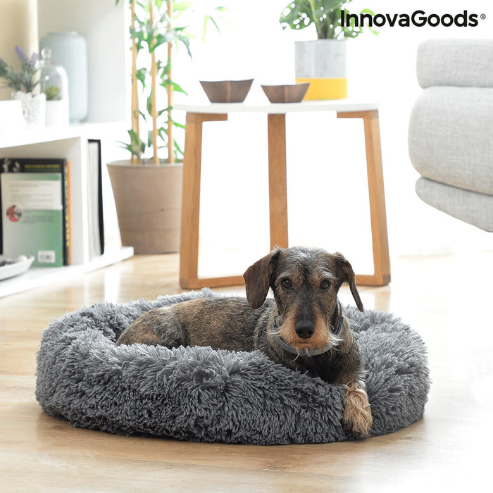 Cama antiestrés gris con perro descansando
